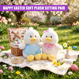 Two plush chicks and small yellow eggs sit on a patterned blanket beside a wicker basket.