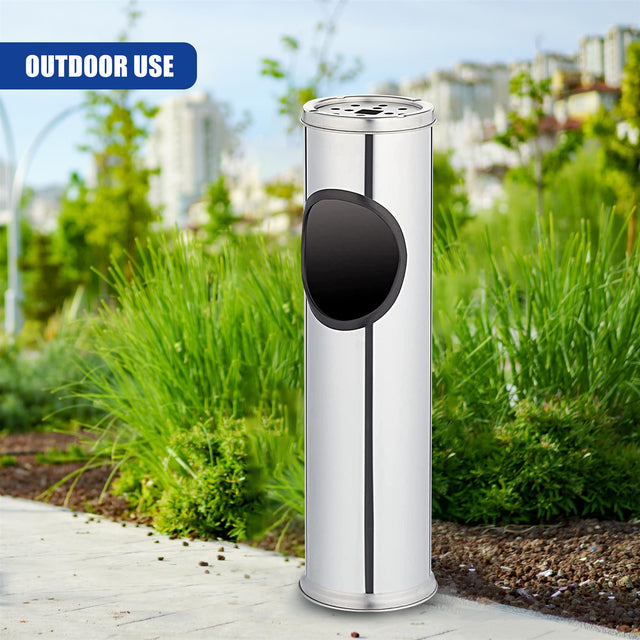 Cylindrical stainless steel outdoor receptacle featuring a top slot and a circular opening.