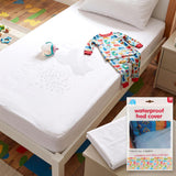 White waterproof bed cover displayed on a single bed near patterned bedding and child toys.