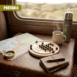 Board game board, map, compass, mug, and thermos sit on a surface by a window view.