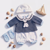 Sailor doll clothing set shown with striped shirt, hat, pants, socks, and miniature wooden sailboats.