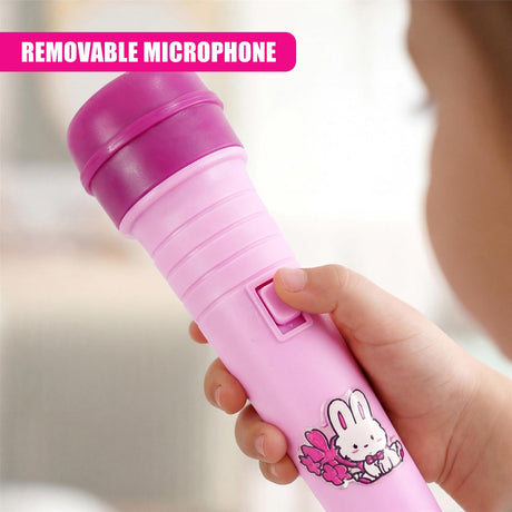 Hand holding a removable pink microphone featuring a bunny graphic on its body.