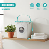 A white container resembling a washing machine sits on a shelf, next to folded white towels and a plant.