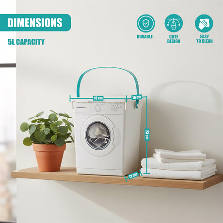 A white container resembling a washing machine sits on a shelf, next to folded white towels and a plant.