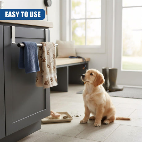 Metallic towel rail mounted on a dark cabinet holds two folded towels on a light tiled floor.