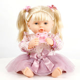 Blonde doll with pigtails, wearing a floral top and pink tulle skirt, holding a baby bottle.