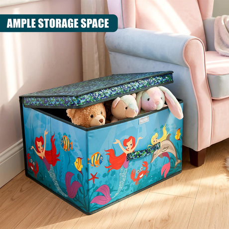 A blue mermaid-themed storage box filled with stuffed toys, placed on a wooden floor next to a pink armchair