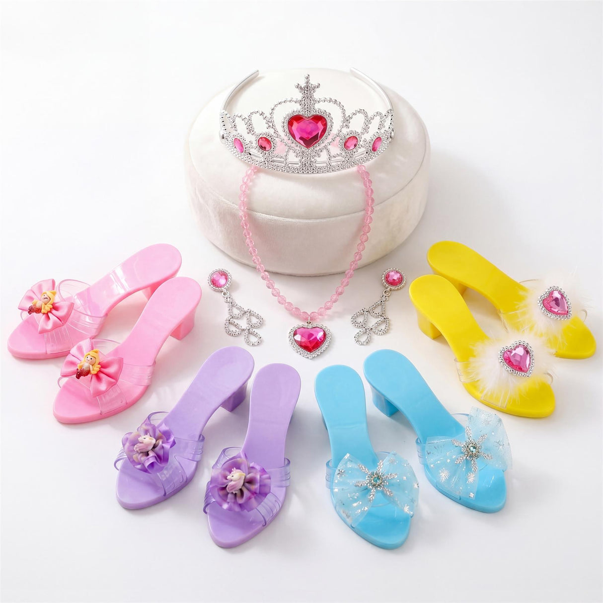 Assortment of children's shoes, a white storage box, crown, necklace, and accessories.