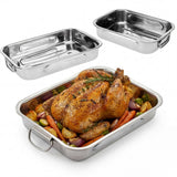 A set of three stainless steel baking trays, one containing roasted poultry and vegetables.