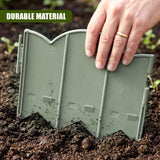 A hand holds a segmented, green plastic garden edging piece lying on dark brown soil.