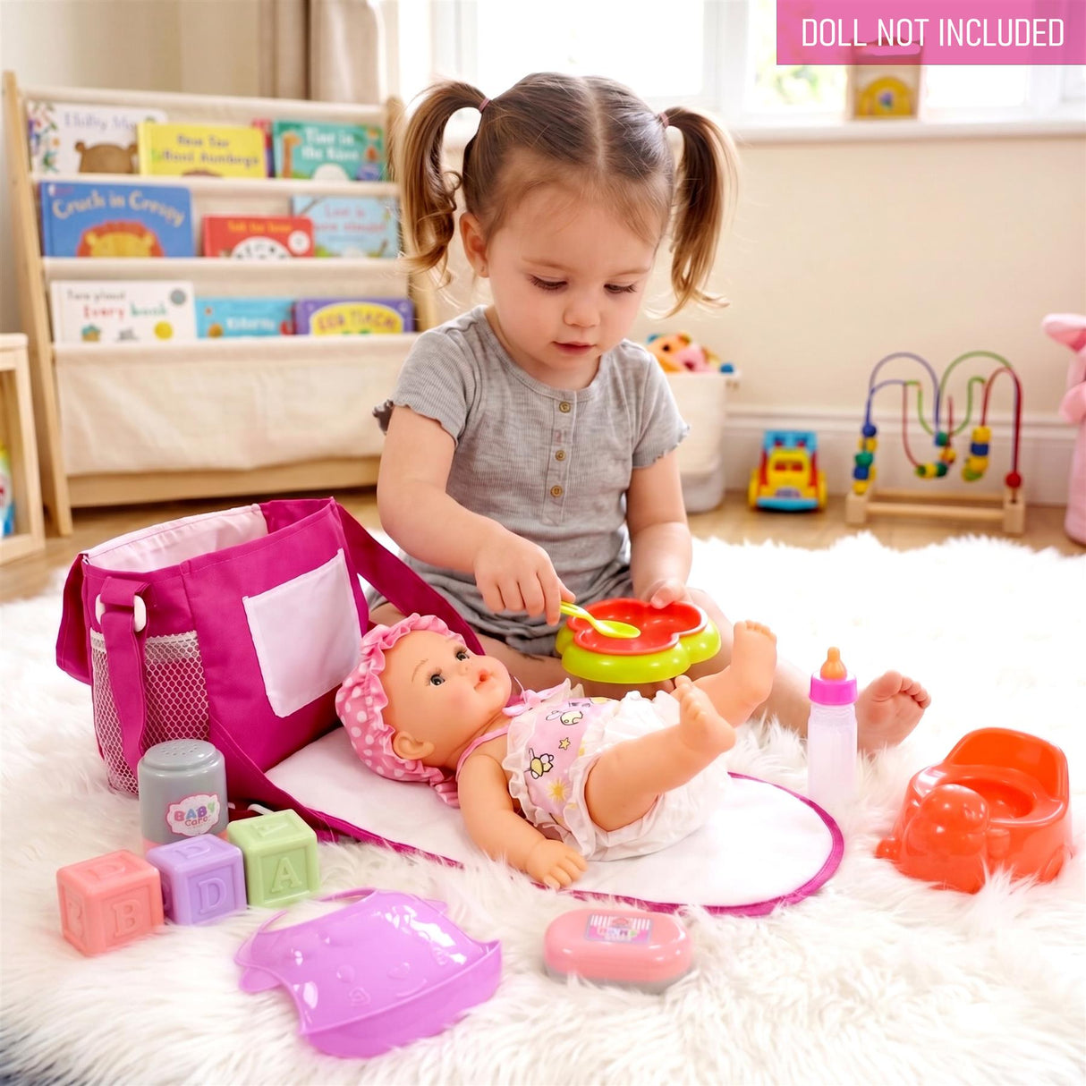 Various baby accessories, including a changing bag, diapers, and toys, are displayed on a soft changing mat.