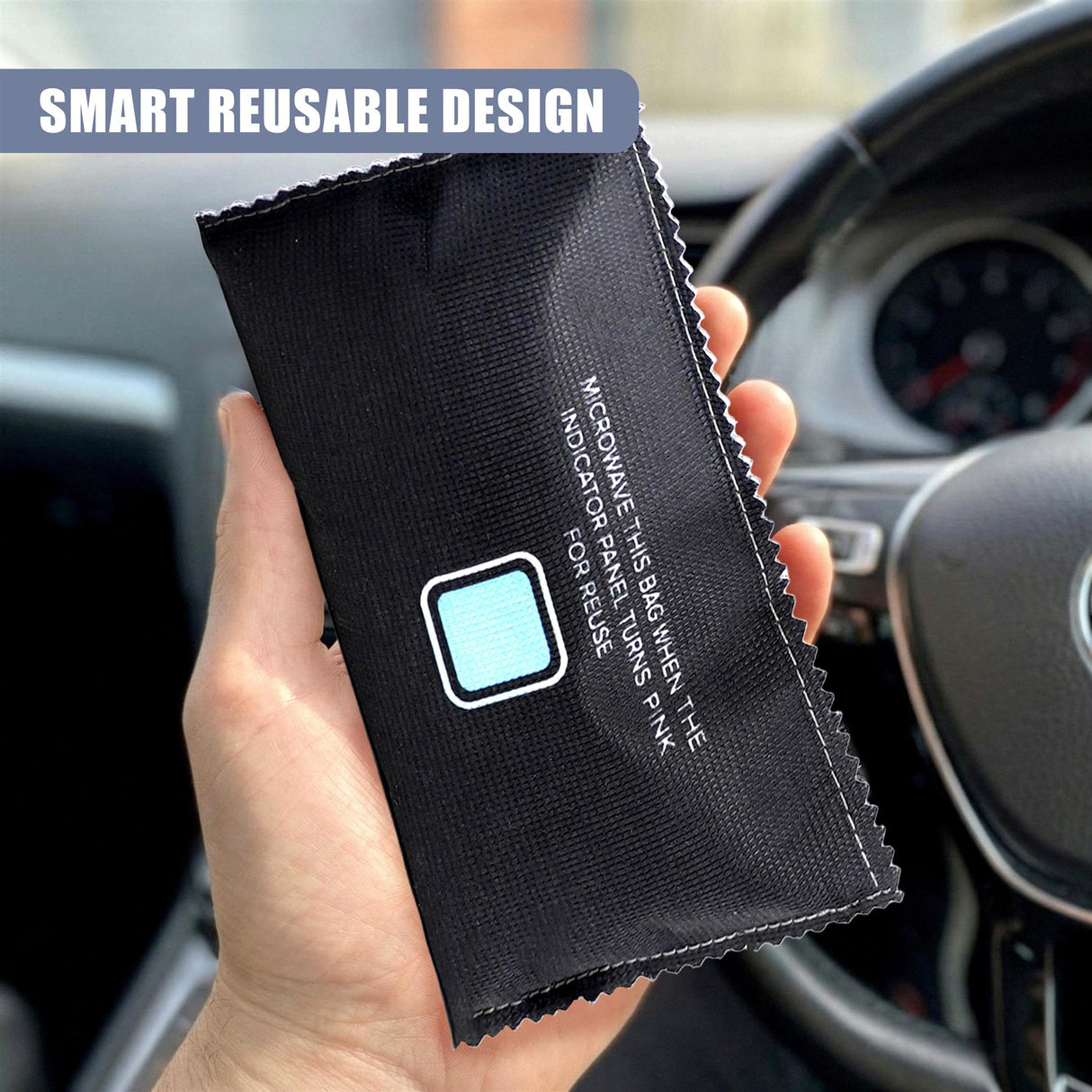 Black fabric bag held against a car interior, featuring white text and a light blue indicator square.