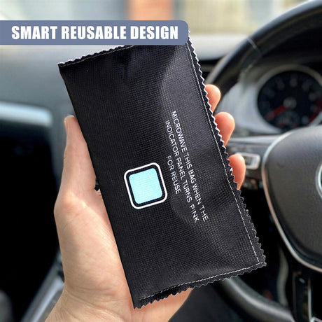 Black fabric bag held against a car interior, featuring white text and a light blue indicator square.