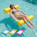 A woman floats on a yellow inflatable hammock; three other colored hammocks are visible below.