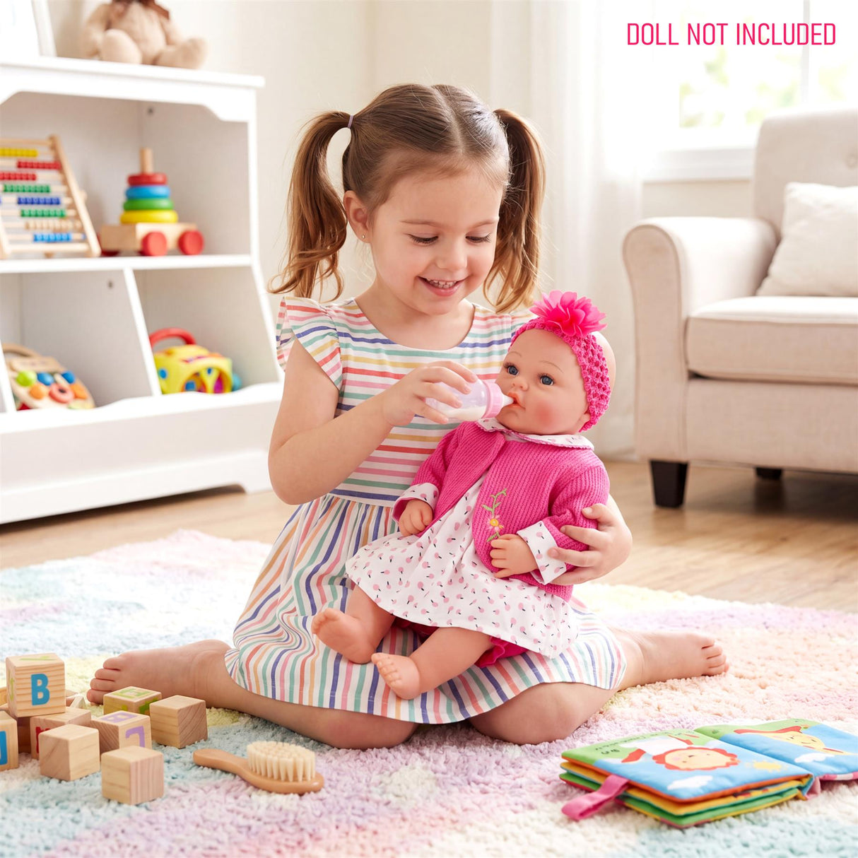 Girl holding a doll in a pink outfit, surrounded by wooden blocks, toys, and living room furniture.