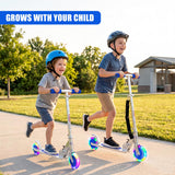 Two children ride a blue three-wheeled scooter on a sidewalk path.