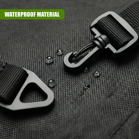 A close-up view of black fabric material showing a zipper and attached plastic hardware loops.