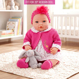 Hot pink cardigan, patterned dress, and headband displayed on a doll with a stuffed bunny toy.