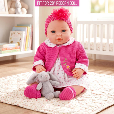 Hot pink cardigan, patterned dress, and headband displayed on a doll with a stuffed bunny toy.