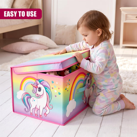 A child in a multi-coloured patterned onesie kneels on a white rug, opening a rainbow unicorn storage box filled with toys