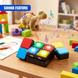 Handheld cube toy features six colored panels on a removable black base, arranged in a square pattern.