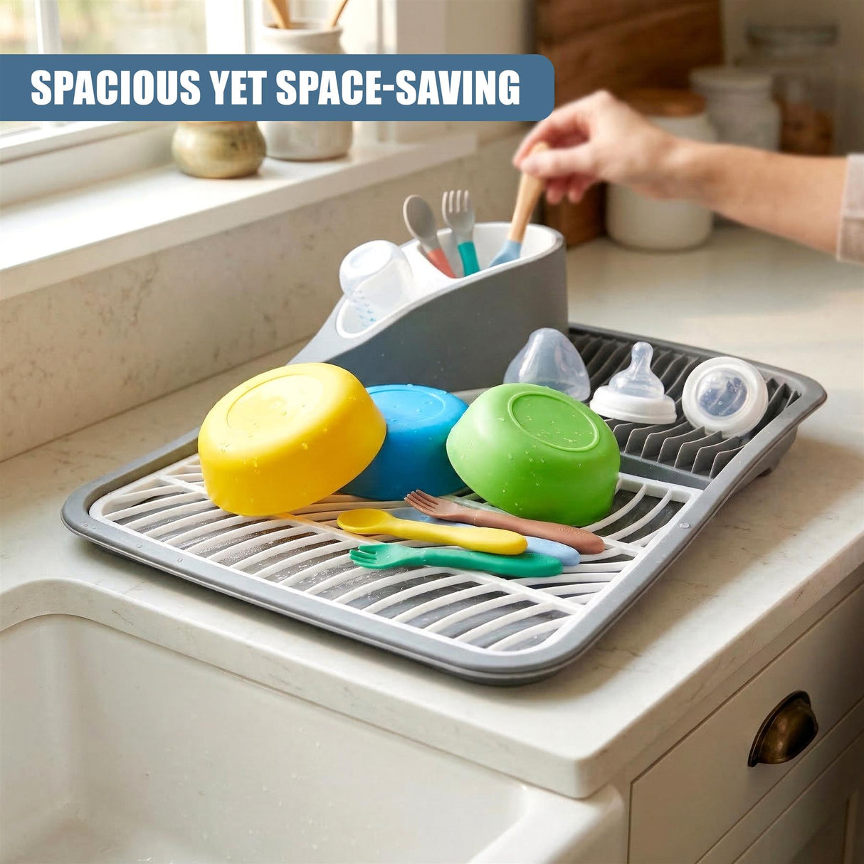 Dish drying rack with various sponges, brushes, and utensils on a kitchen counter.