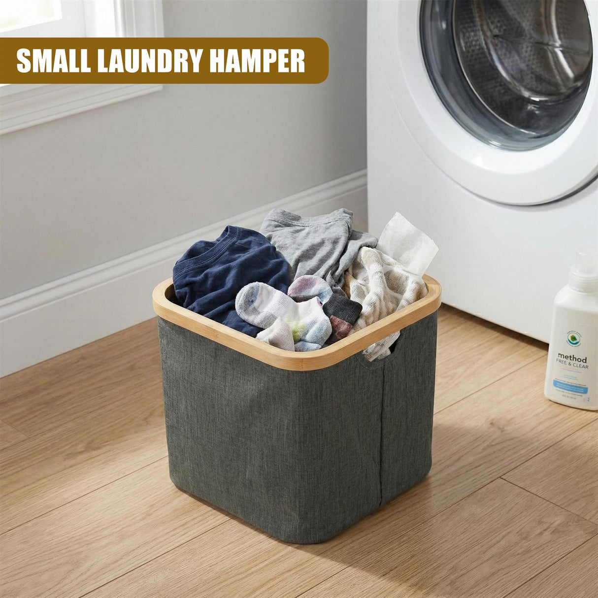 Gray fabric laundry hamper filled with clothes, positioned next to a white washing machine.