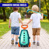 Two children play with a green cart and a teal golf club on a paved path outdoors.