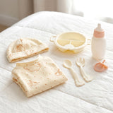 A white baby set featuring a hat, bib, feeding tray, bottle, and meal utensils.