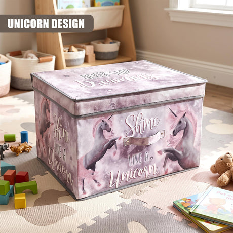 A large pink unicorn storage box with a lid featuring the text "Shine like a Unicorn" sits on a play mat surrounded by toys