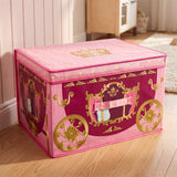 A pink and purple foldable storage box shaped like a princess carriage with gold wheels and crown details on a wooden floor