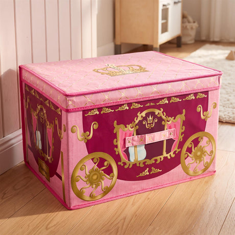 A pink and purple foldable storage box shaped like a princess carriage with gold wheels and crown details on a wooden floor