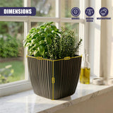 Black vertical planter filled with green herbs rests on a light-colored windowsill.