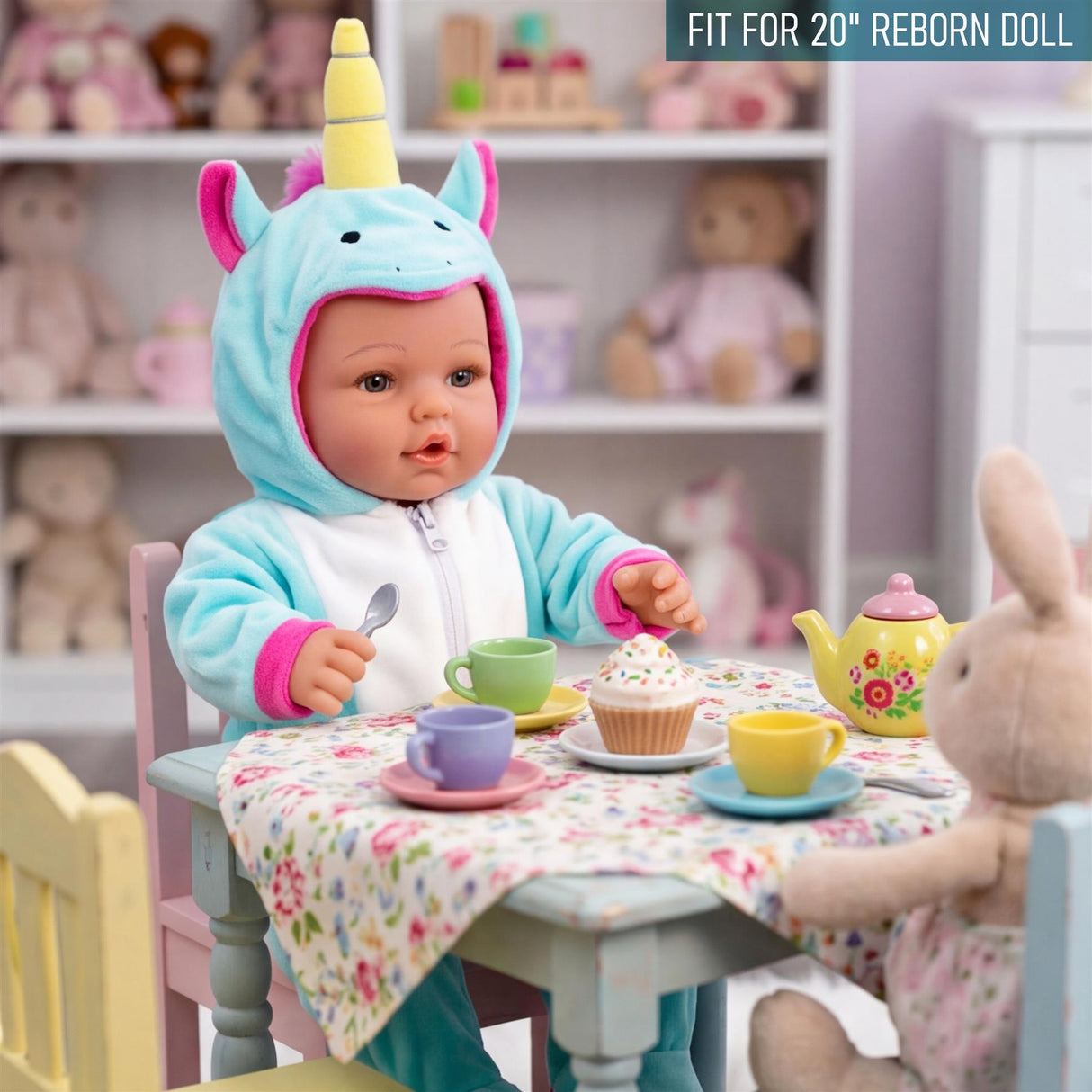 A doll in a blue unicorn outfit sits at a table with treats and a plush bunny toy.