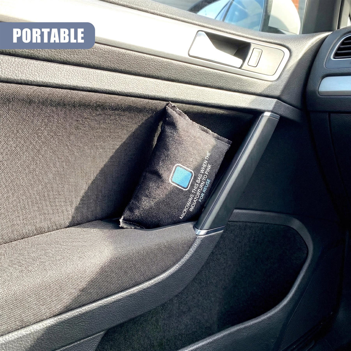 Black fabric pouch with white lettering rests inside the storage compartment of a car console.