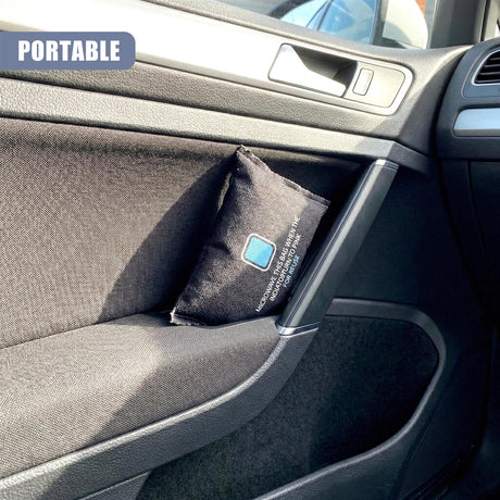 Black fabric pouch with white lettering rests inside the storage compartment of a car console.