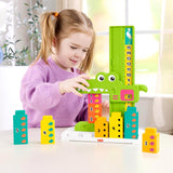 Young girl plays with an alligator math toy that features a number ladder and colorful counting blocks.