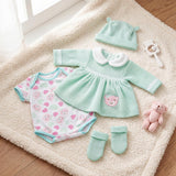 Doll outfit set includes a mint green dress, pink onesie, matching hat, socks, and stuffed plush toy.