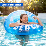 Blue inflatable tube floating in water, featuring the white letters spelling "ON A BEACH."