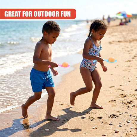 Two children race on the beach, each holding a plastic egg and spoon.