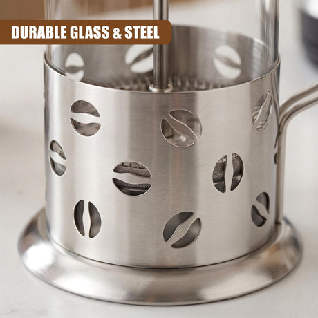 Stainless steel pour-over cafetiere displaying coffee bean cutout details on the main body.