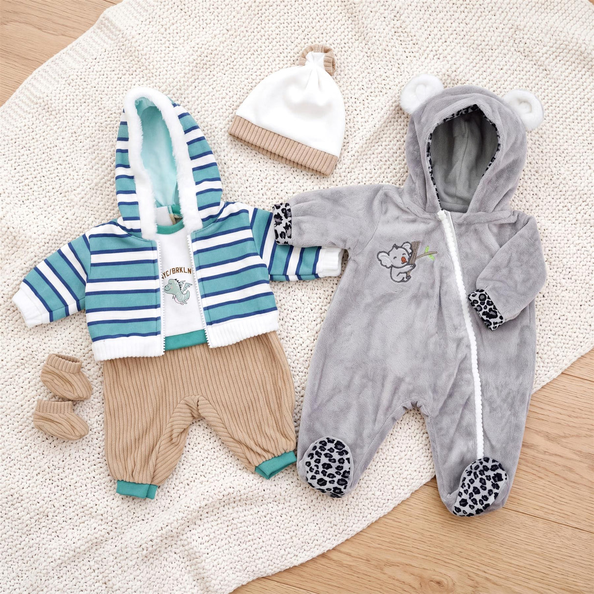 Set of two doll clothes: striped top, pants, and a grey koala-themed hooded jumpsuit.