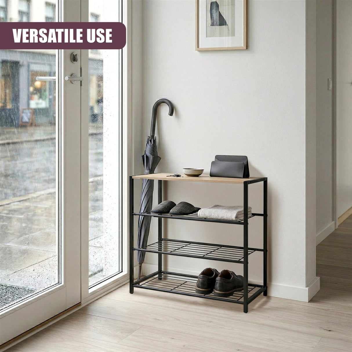 Three-tiered black metal shoe rack with open shelves and a flat seating surface.