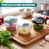 Three food choppers filled with chopped vegetables and herbs sit on a wooden cutting board.