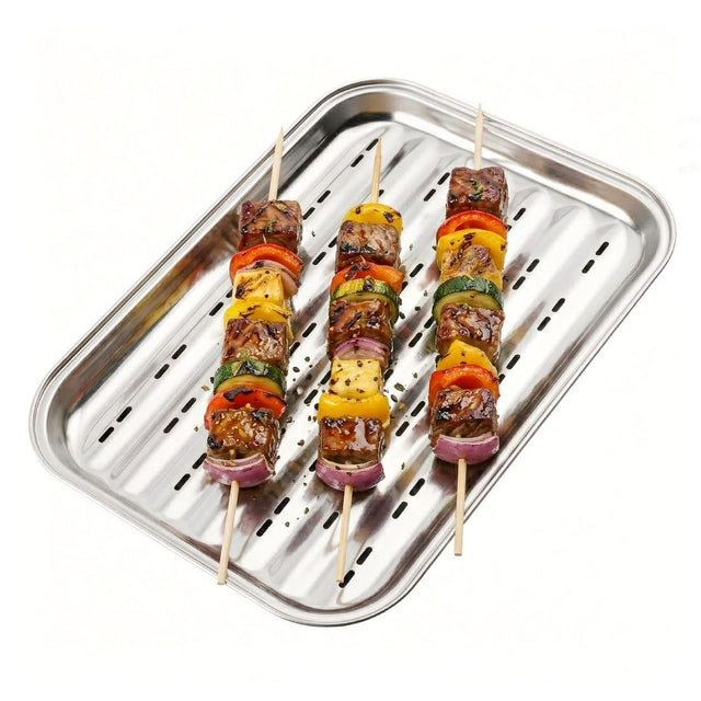 Grilled skewers of meat and vegetables rest on a rectangular, perforated metal grill tray.