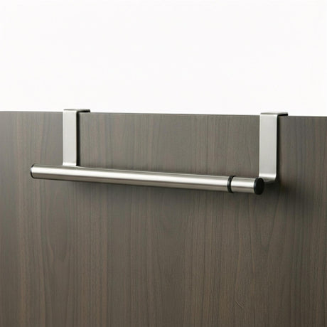 Silver metal rail with end brackets mounts horizontally on a dark wood surface for hanging towels.