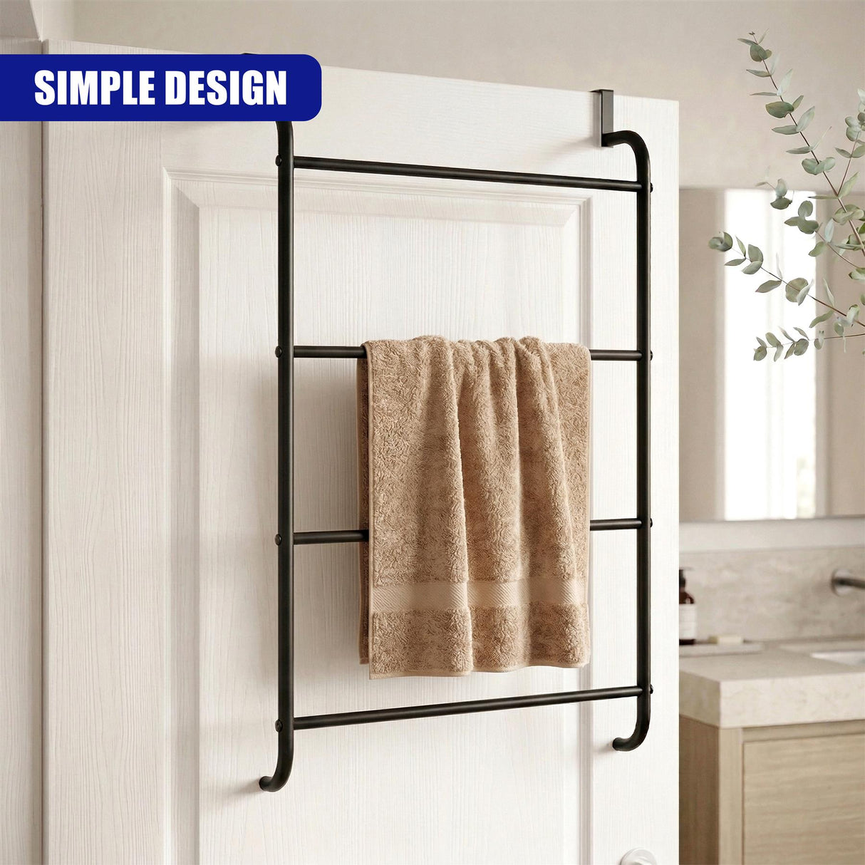 Black ladder-style towel rail mounted on a white door with a tan towel draped across it.