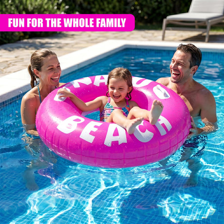 A pink inflatable ring spelling "BEACH" floats in a swimming pool surrounded by family members.