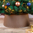 Brown Christmas tree skirt with a basket weave pattern under a decorated tree