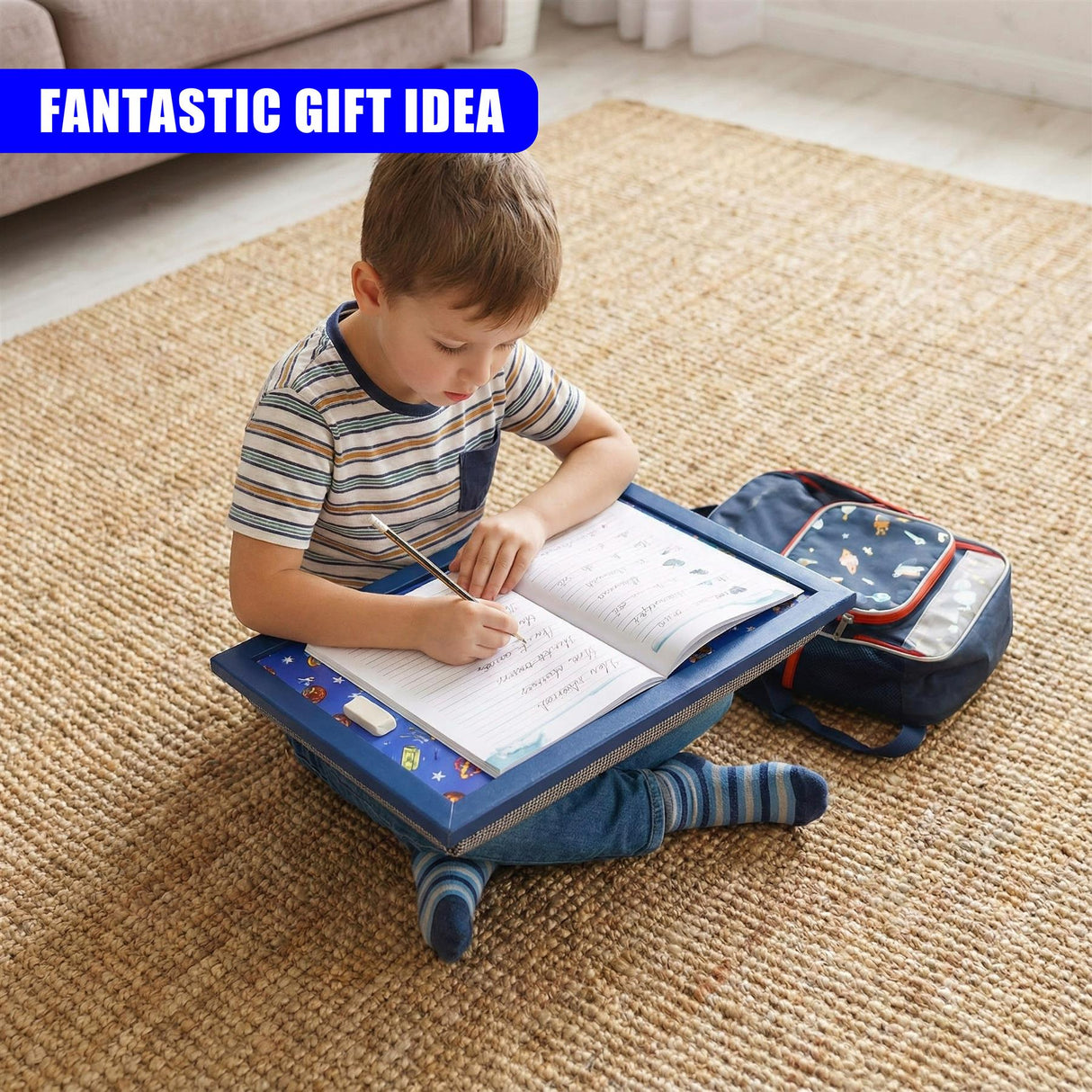 Child writing at a portable blue lap tray positioned on a cushion and rug.